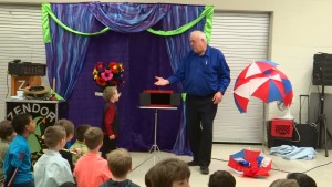 Zendor invites a young man up to the stage